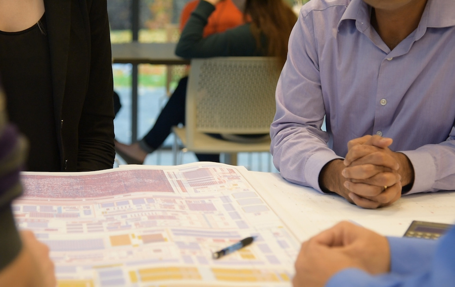 Employees discuss electrical diagram