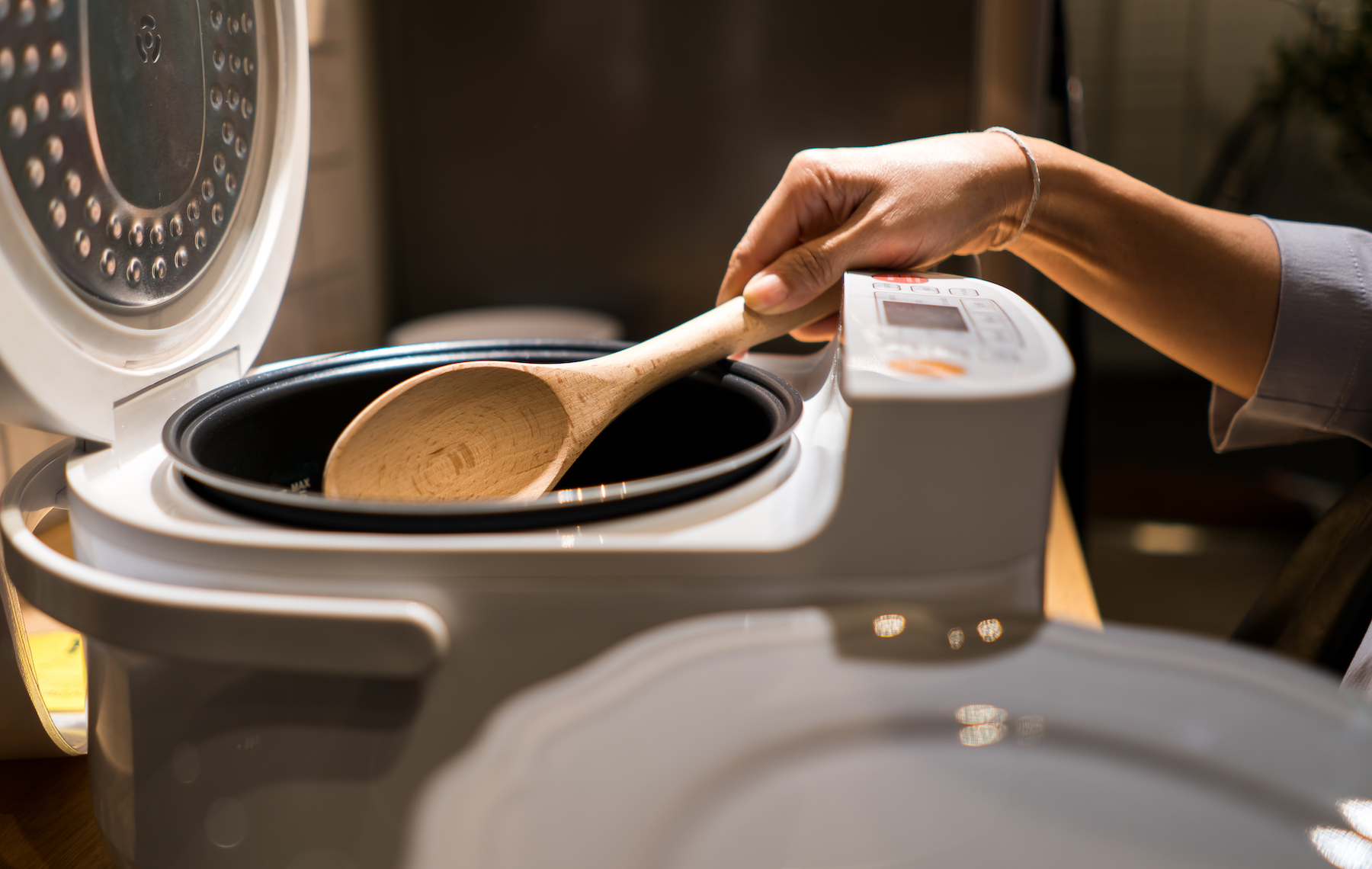 Scooping rice out of a rice cooker