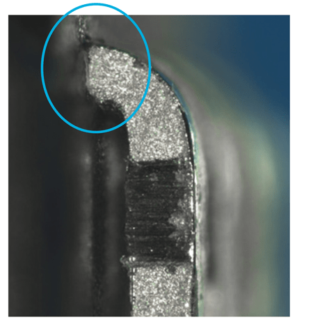 Figure 29. This is an example of an unacceptable pin bend, showing no clamping was used and the pin too close to the package case. Circled area of disturbance indicates potential internal damage.